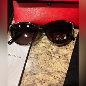 Guess Women's Tortoise Shell Sunglasses with gold embellishments per lens.